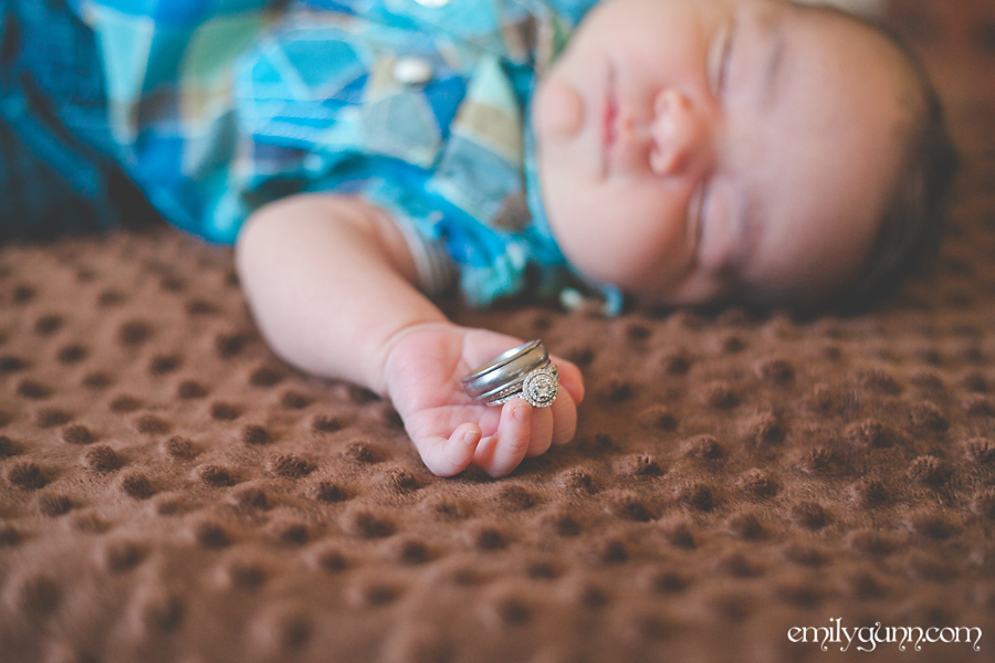 Professional natural light photo of a baby boy with wedding rings